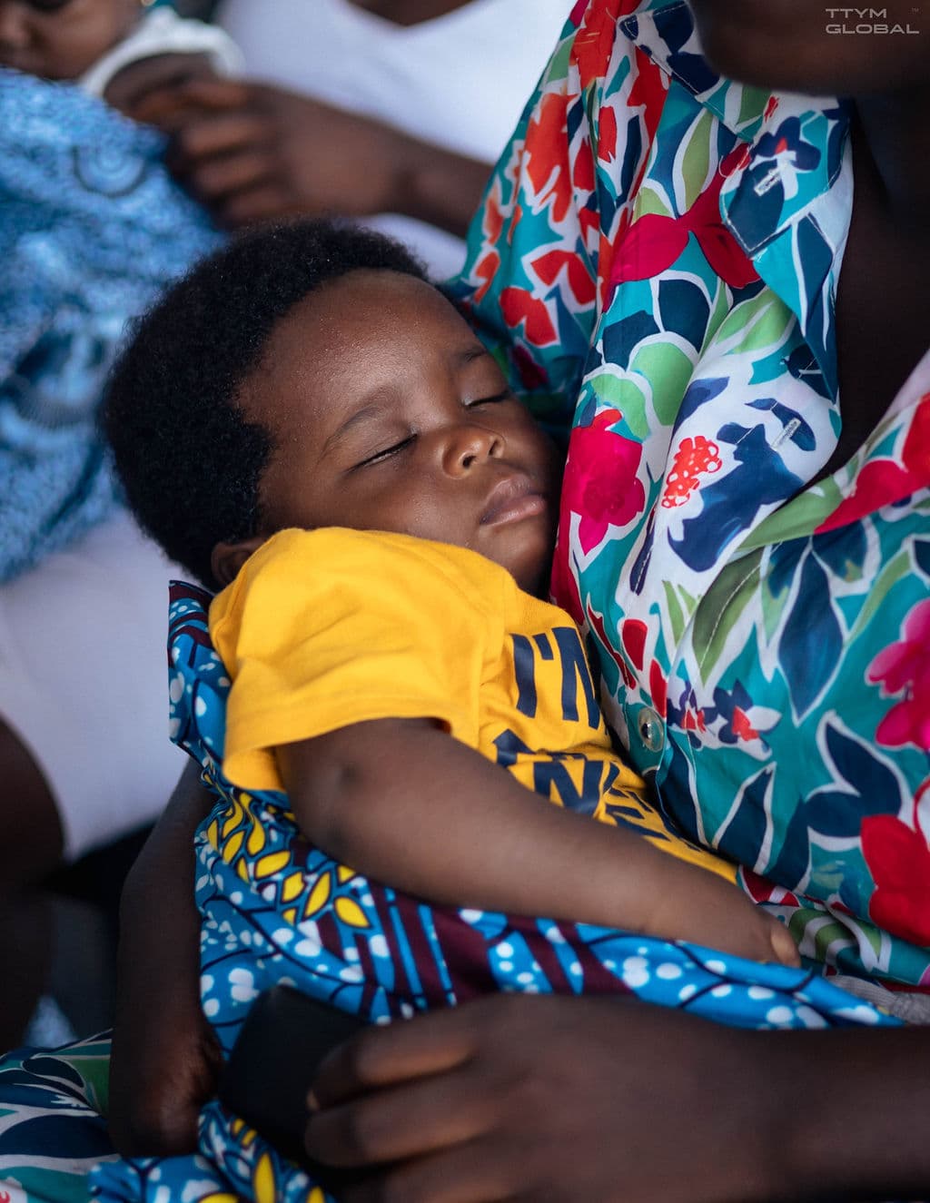 sleeping baby in mum's arms